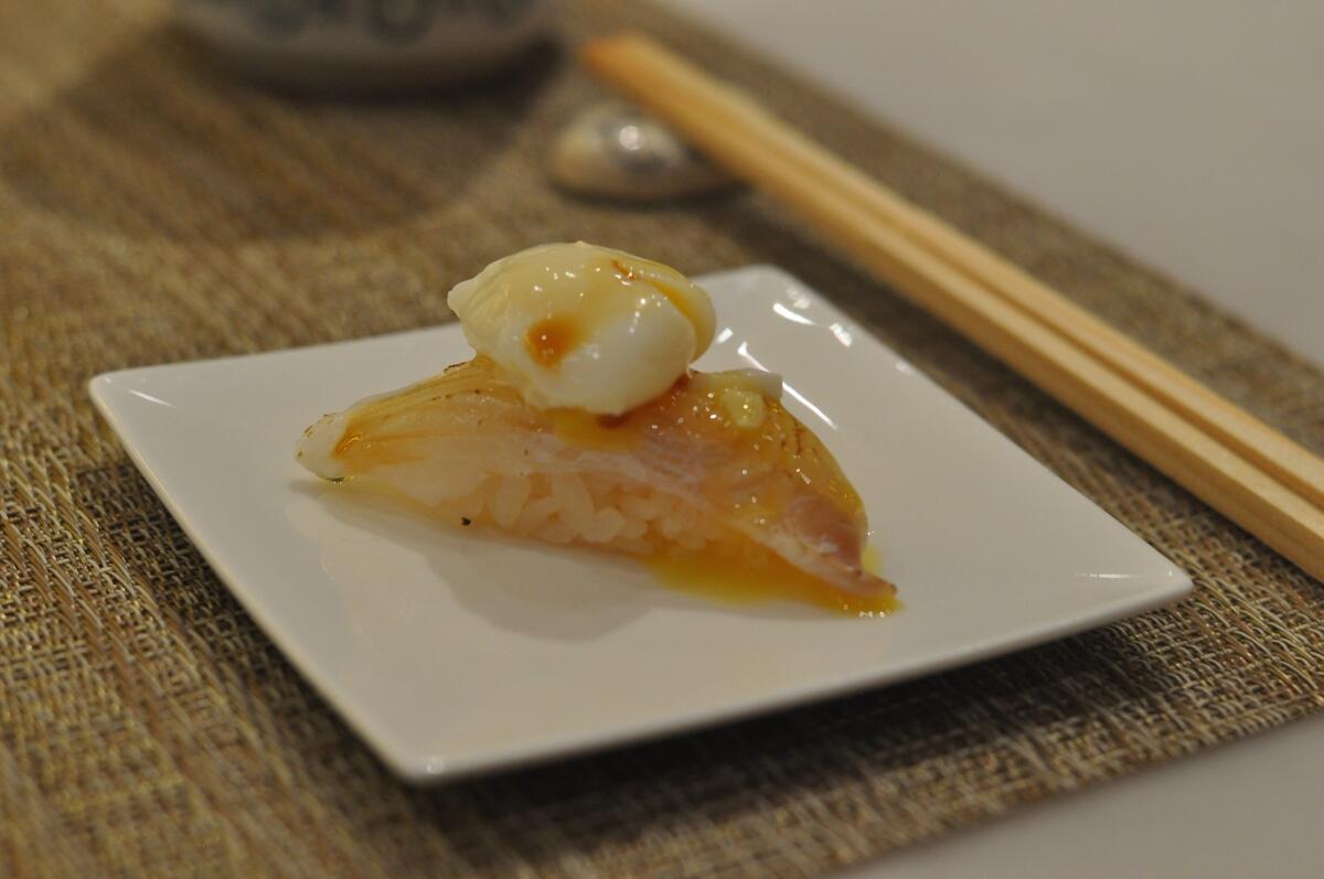Halibut sushi with poached quail egg and truffle oil.