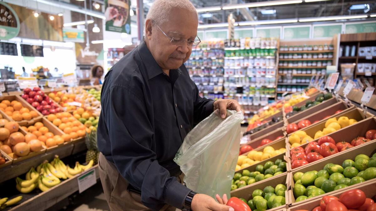 A shopper examines produce at a Whole Foods store in Chicago.