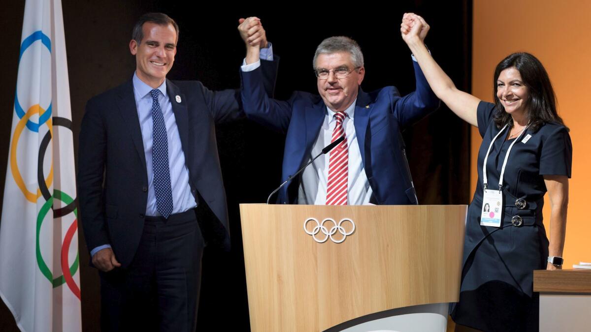 Mayor of Paris Anne Hidalgo, IOC President Thomas Bach and Los Angeles Mayor Eric Garcetti in Lausanne, Switzerland, on July 11.