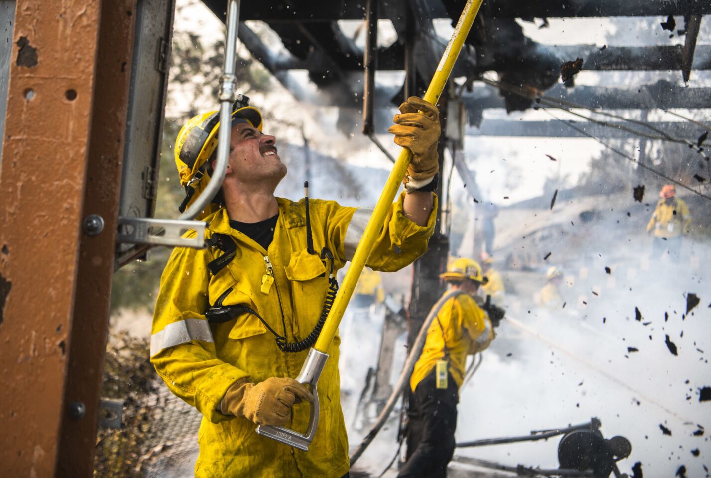 A Los Angeles County Firefighter fights a structure fire at Camp 13, an inmate fire crew camp run by the Los Angeles County Fire Department off Decker Road above Malibu.