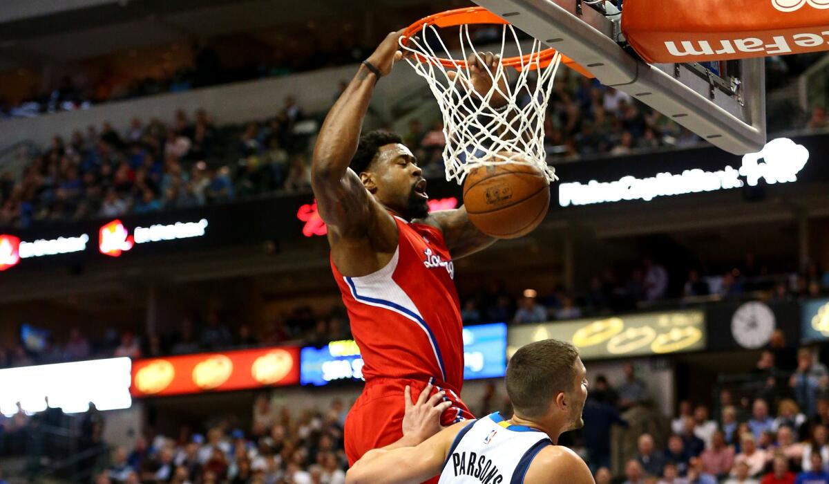 Clippers center DeAndre Jordan finishes off a dunk against the Mavericks on March 13. Which uniform will he be wearing next season?