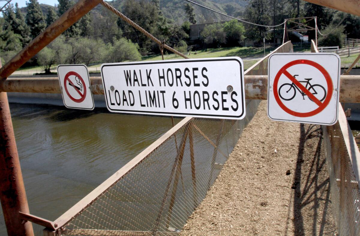 Signs stating the user rules of the Mariposa Street Bridge are clearly posted at the top of the bridge, in Burbank on Thursday, Jan. 28, 2016.