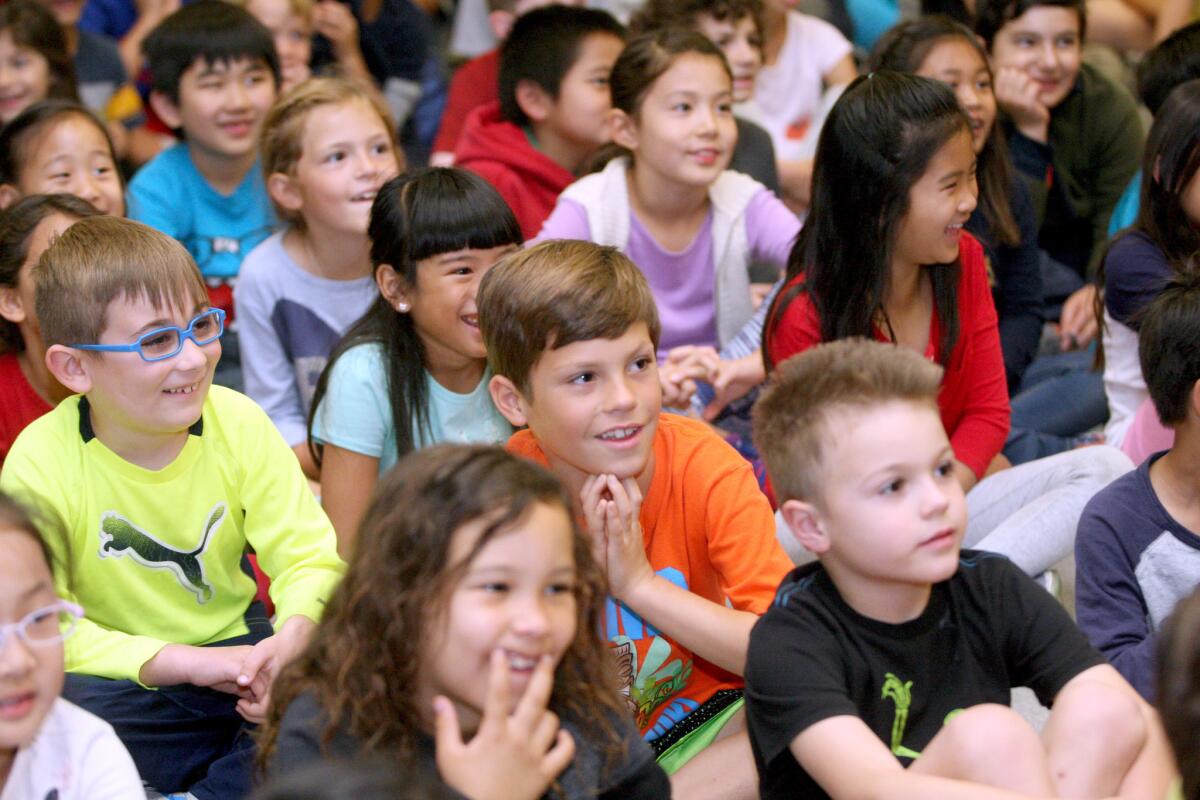 Students enjoy short acts by Writer's Room Productions' that were written by students for the a school program showcasing student authors, at La Cañada Elementary School on March 4, 2016. Nine stories written by students from all grade levels were acted out during two assemblies for the school students.