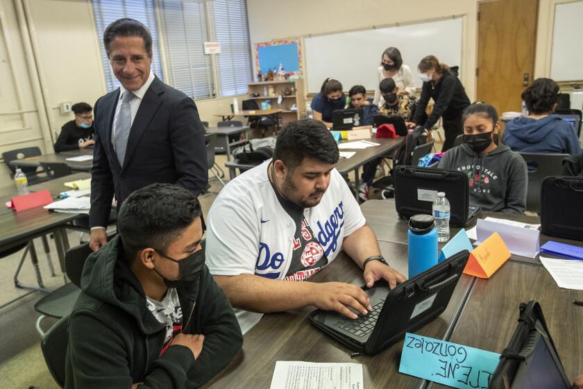 CANOGA PARK, CA-JUNE 24, 2022:LAUSD Superintendent Alberto Carvalho, left, observes students in an international newcomer enrichment summer program at Canoga Park High School for new students to our country to gain language acquisition. (Mel Melcon / Los Angeles Times)