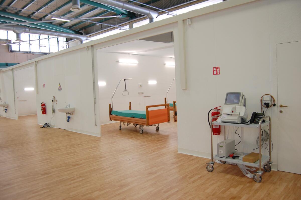 The hallways in the Alpini field hospital were designed to be extra wide, and the patient wards have walls but no ceilings to help the air circulate better and prevent the disease from spreading to healthcare workers.