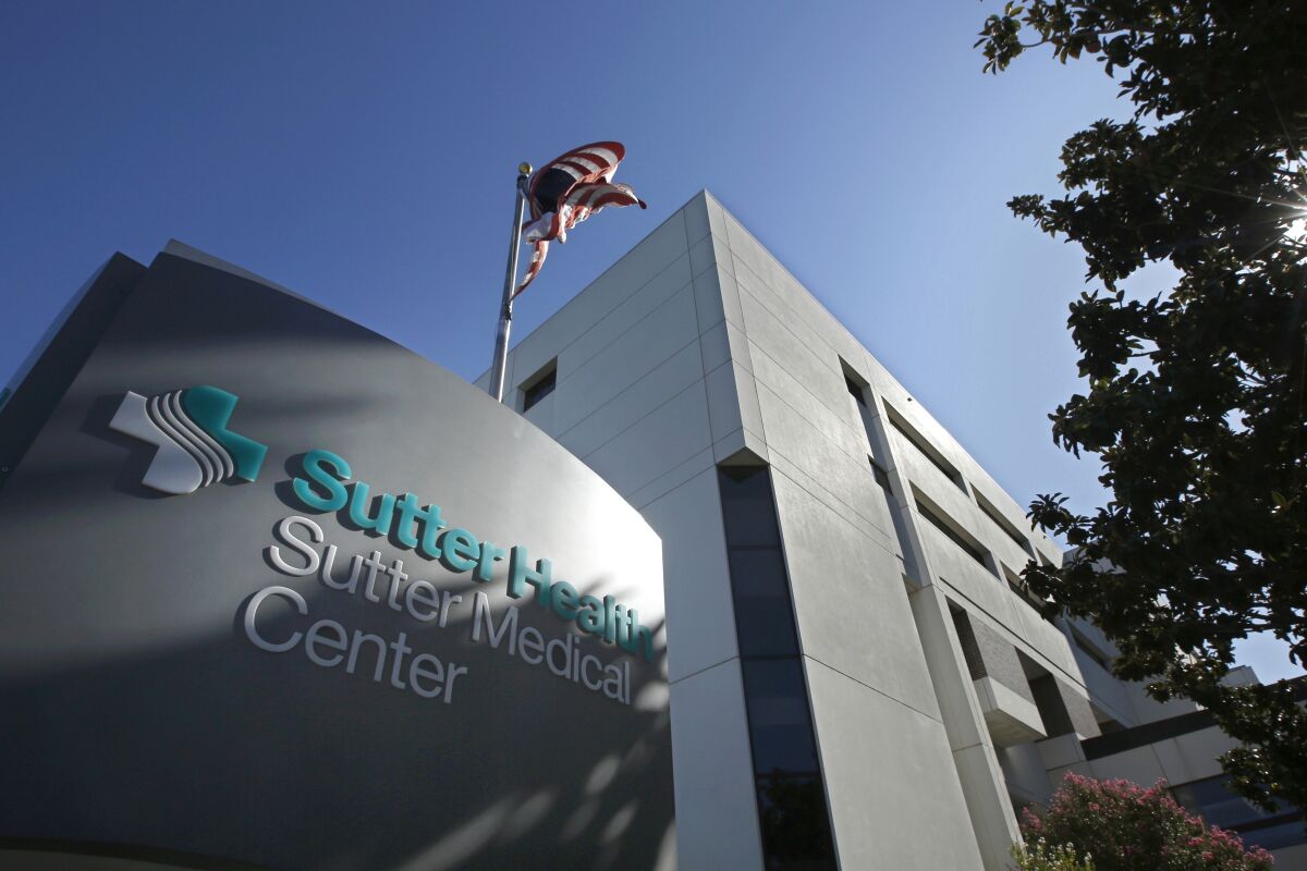An American flag flutters in the breeze at the Sutter Medical Center in Sacramento