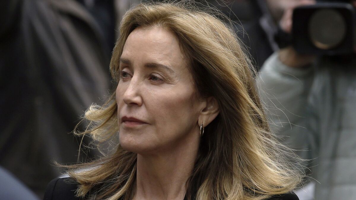 Felicity Huffman arrives at federal court Monday in Boston, where she pleaded guilty to charges in a nationwide college admissions bribery scandal.