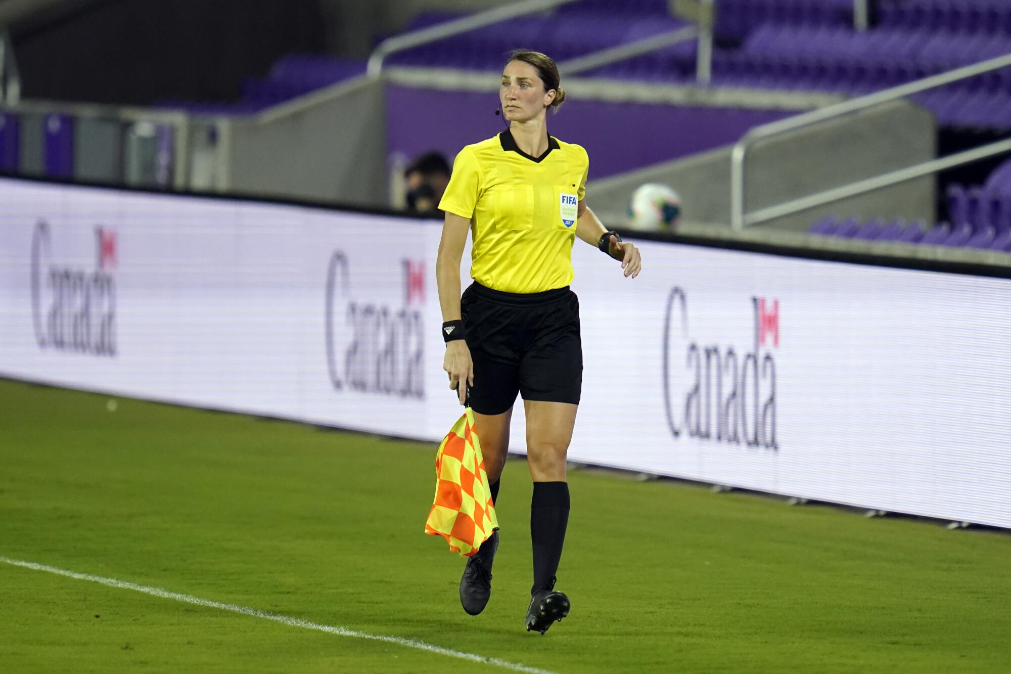 Assistant referee Kathryn Nesbitt runs the sideline during a Bermuda-Canada World Cup qualifying match on March 25, 2021.