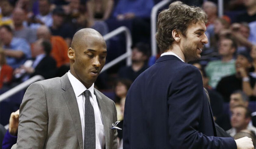 Injured Lakers stars Kobe Bryant, left, and Pau Gasol were in street clothes as their teammates took on the Phoenix Suns on Monday.