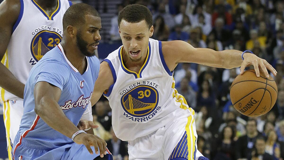 Golden State Warriors point guard Stephen Curry, right, tries to drive past Clippers point guard Chris Paul during the Clippers' 106-98 loss on March 8.