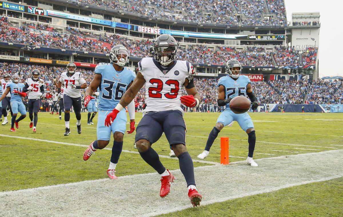 Texans running back Carlos Hyde scores a touchdown against the Titans on Sunday.