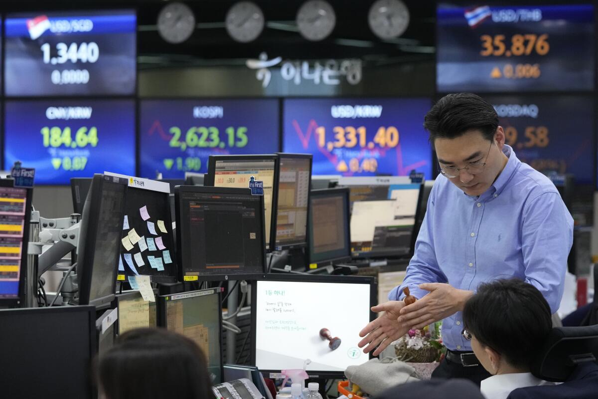 A currency trader watches computer monitors