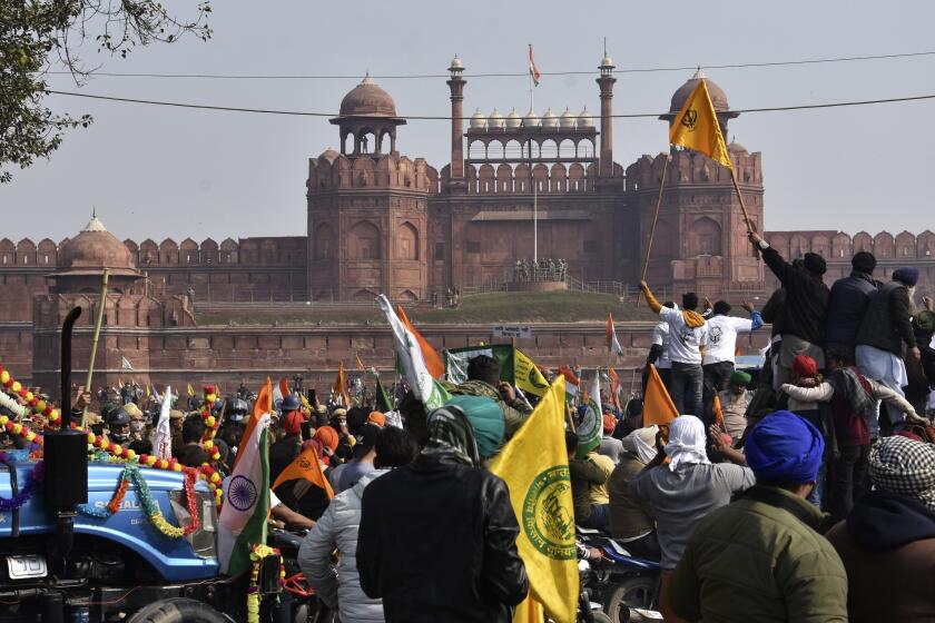 Protesting farmers arrive with their tractors at the historic Red Fort monument in New Delhi, India, Tuesday, Jan. 26, 2021. Tens of thousands of protesting farmers drove long lines of tractors into India's capital on Tuesday, breaking through police barricades, defying tear gas and storming the historic Red Fort as the nation celebrated Republic Day. (AP Photo/Dinesh Joshi)