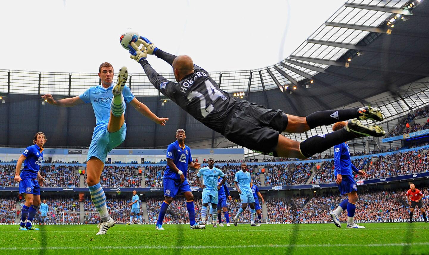 Edin Dzeko of Manchester City challenges as Tim Howard of Everton saves during the Barclays Premier League match between the two teams at the Etihad Stadium on Sept. 24, 2011.