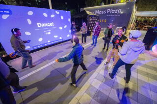 A group of people wearing headphones dancing individually.