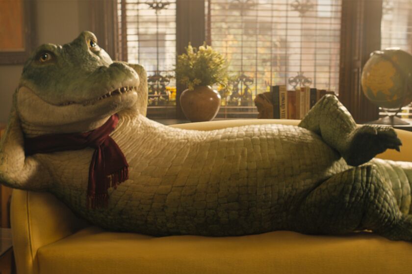 A crocodile wearing a scarf poses on a couch