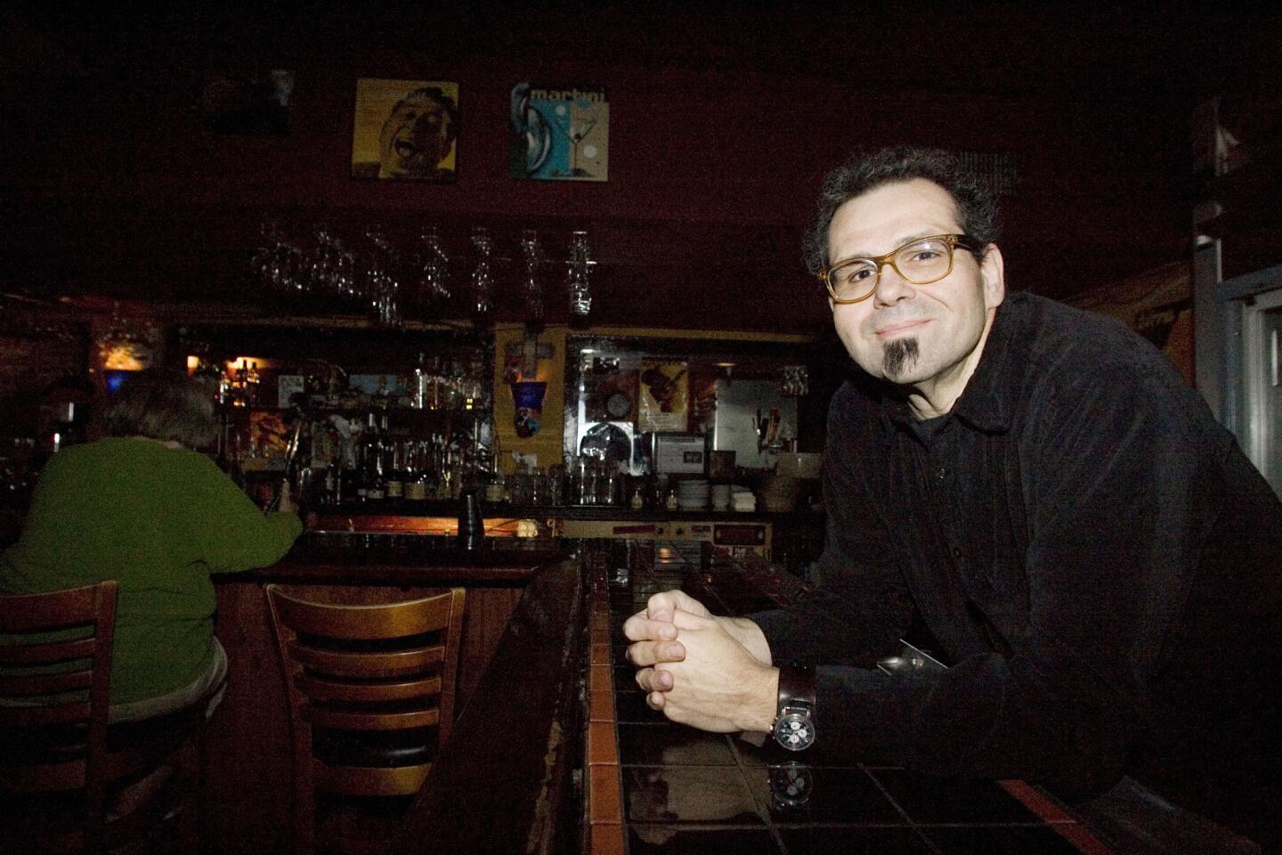 Mario Lalli poses for the camera at Cafe 322 in Sierra Madre on Wednesday, March 14, 2012. Cafe 322 is a family run business owned by Mario. Mario is also a musician and has been a major influence on bands like Queens of the Stone Age and Kyuss.