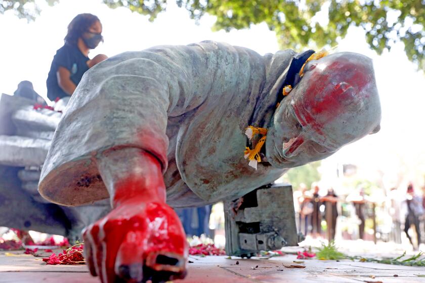 LOS ANGELES, CA - JUNE 20: Activists topple and deface with red paint the statue of Father Junipero Serra (1713 - 1784) at Father Serra Park in Pueblo Amigo on Saturday, June 20, 2020 in Los Angeles, CA. Junipero Serra, a Roman Catholic Spanish priest, who found the first nine of 21 Spanish missions in California from San Diego to San Francisco, in what was then Alta California in the Province of Las Californias, New Spain. (Gary Coronado / Los Angeles Times)