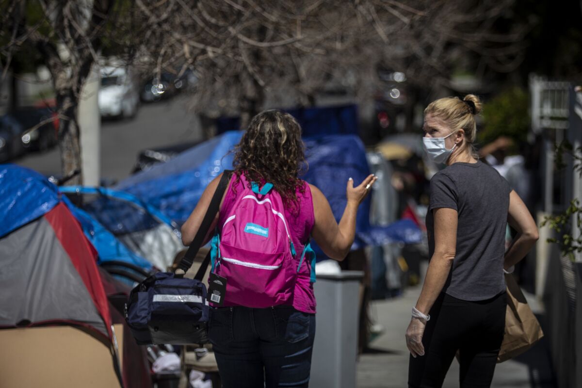 Dr. Susan Partovi, left, and registered nurse Heidi Roth visit a homeless encampment in Los Angeles. “We’re really blessed to have our homes to stay in with our families," Roth said. "But so many people have nobody, and if we as providers can’t help them, who will?”
