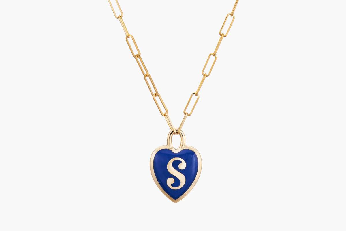 A blue heart pendant with the initial "S." 