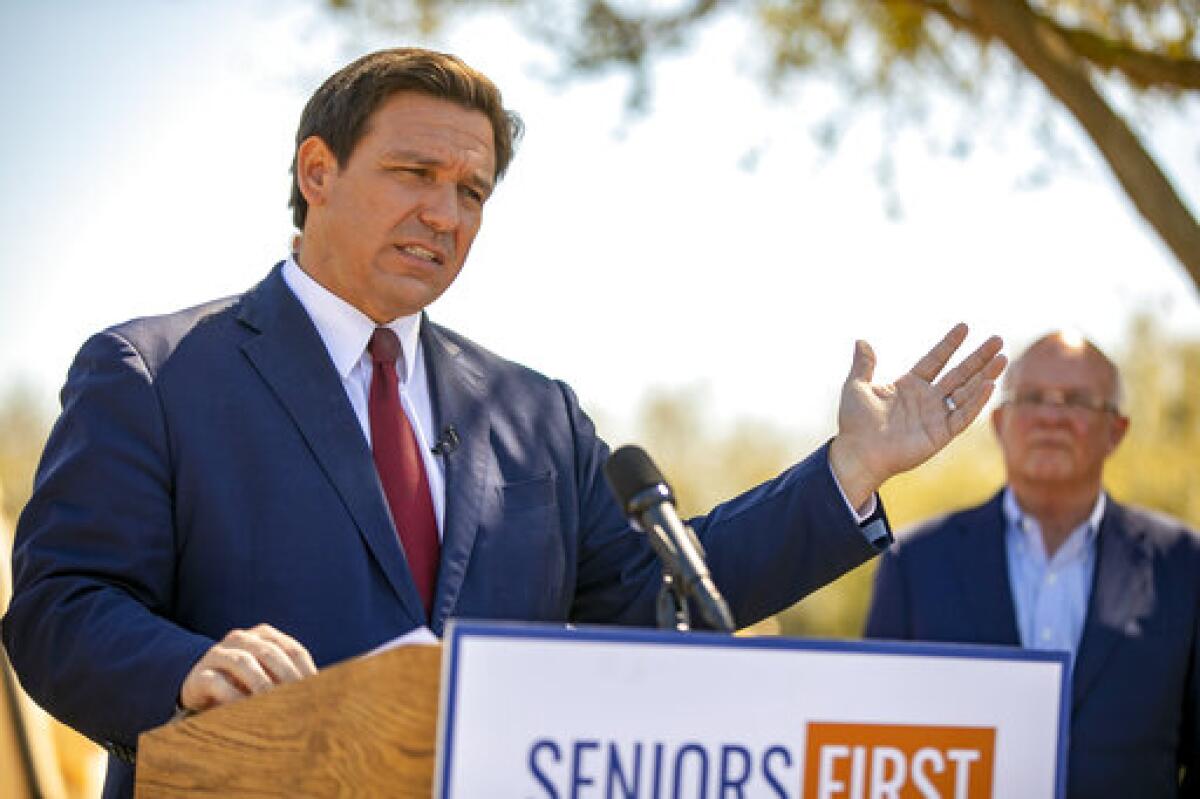 FILE - In this March 5, 2021 file photo, Florida Gov. Ron DeSantis speaks to the media as he visited the drive-thru COVID-19 vaccination site at On Top of the World in Ocala, Fla., Repealing statewide mask mandates and criticizing the Biden administrationâ€™s unemployment-based formula for distributing billions in federal aid has put Republican governors and their approach to handling the coronavirus pandemic back in the spotlight. (Alan Youngblood/Ocala Star-Banner via AP)