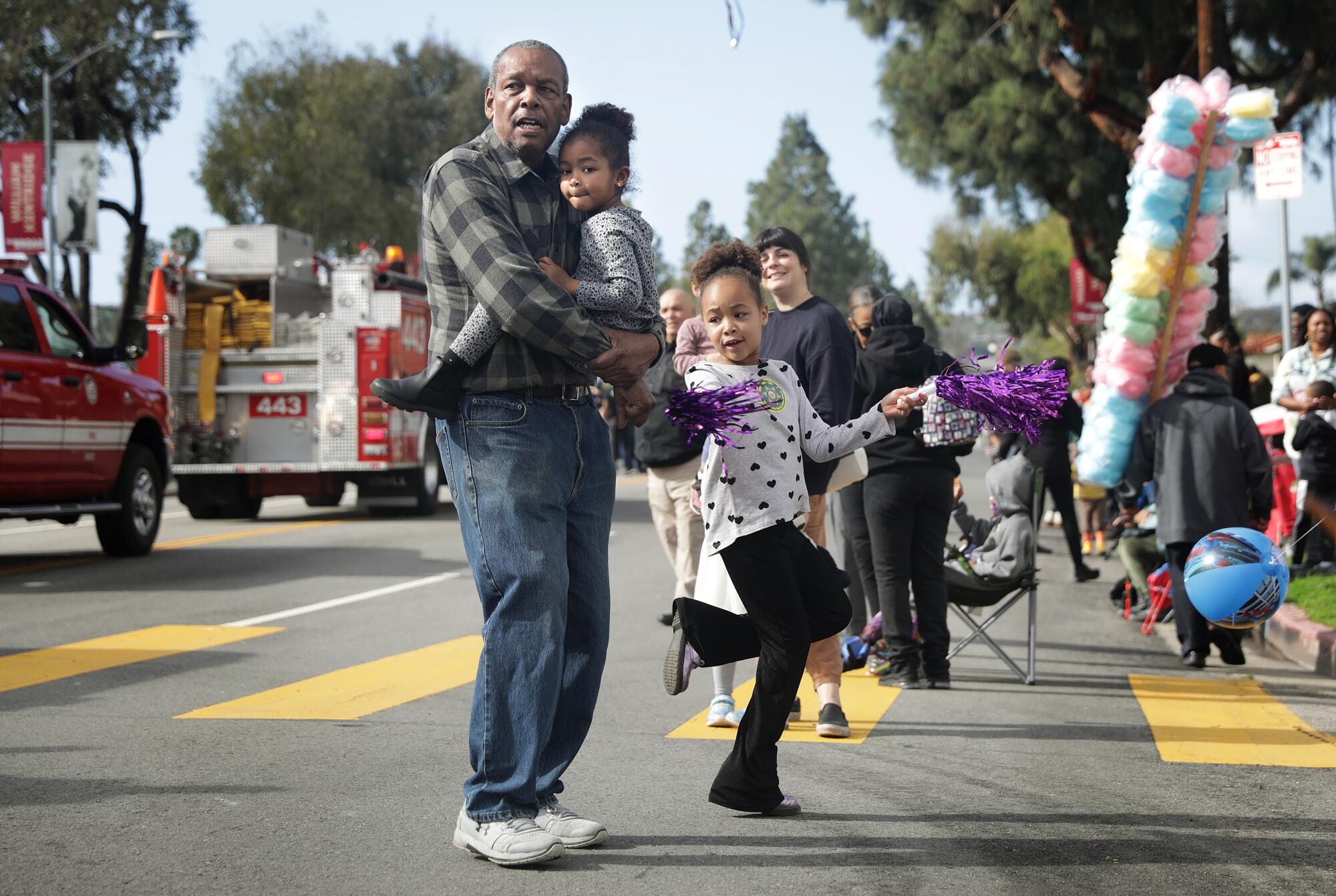 Paradegoers watch participants in the 38th Annual Kingdom Day Parade in Leimert Park.