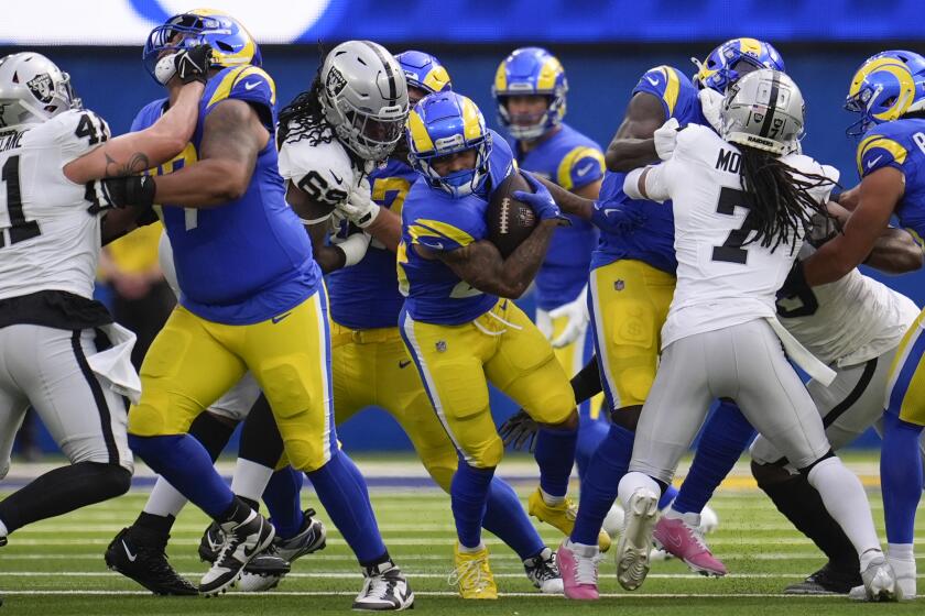 Los Angeles Rams running back Kyren Williams (23) runs with the ball during the first half.