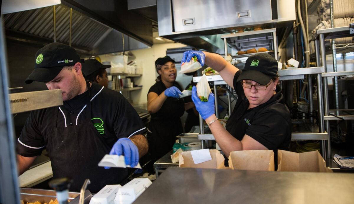 Workers prepare orders in the original Shake Shack in Madison Square Park in New York City.