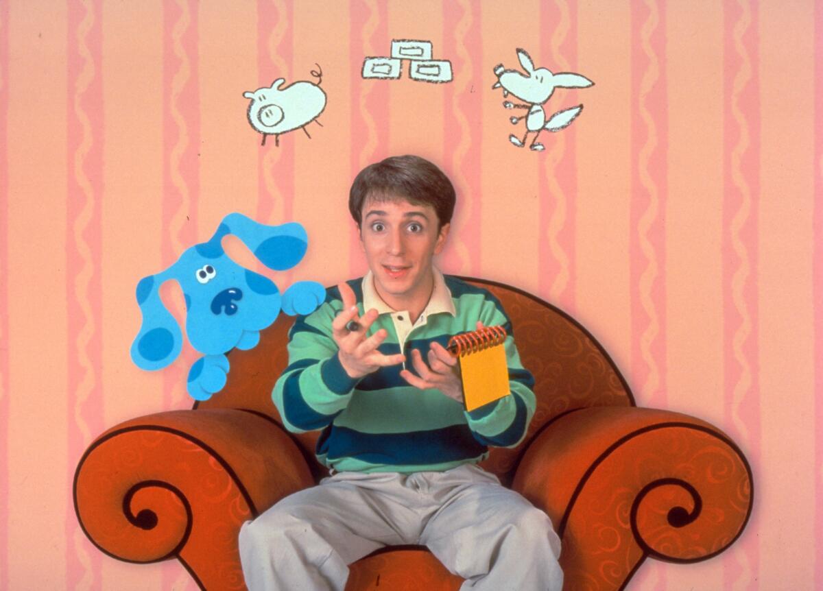 A young man sits on a chair surrounded by animated animals