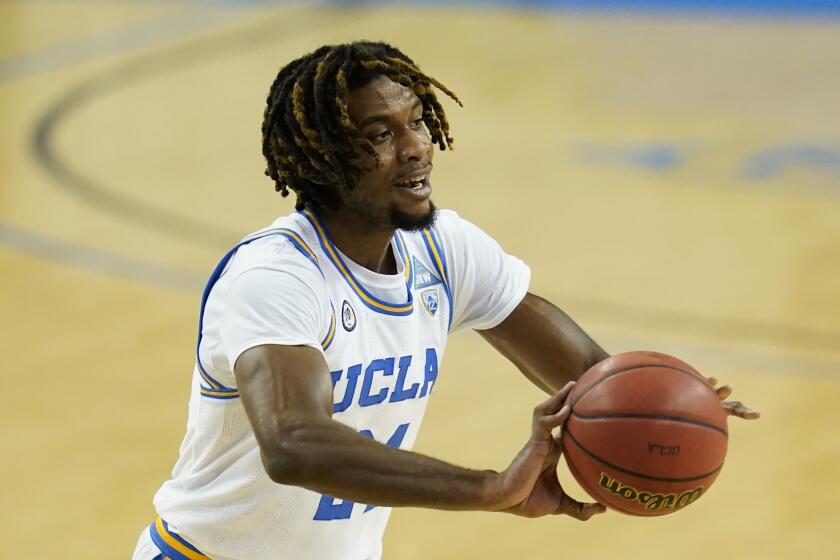 UCLA forward Jalen Hill (24) passes the ball during an NCAA college basketball game.