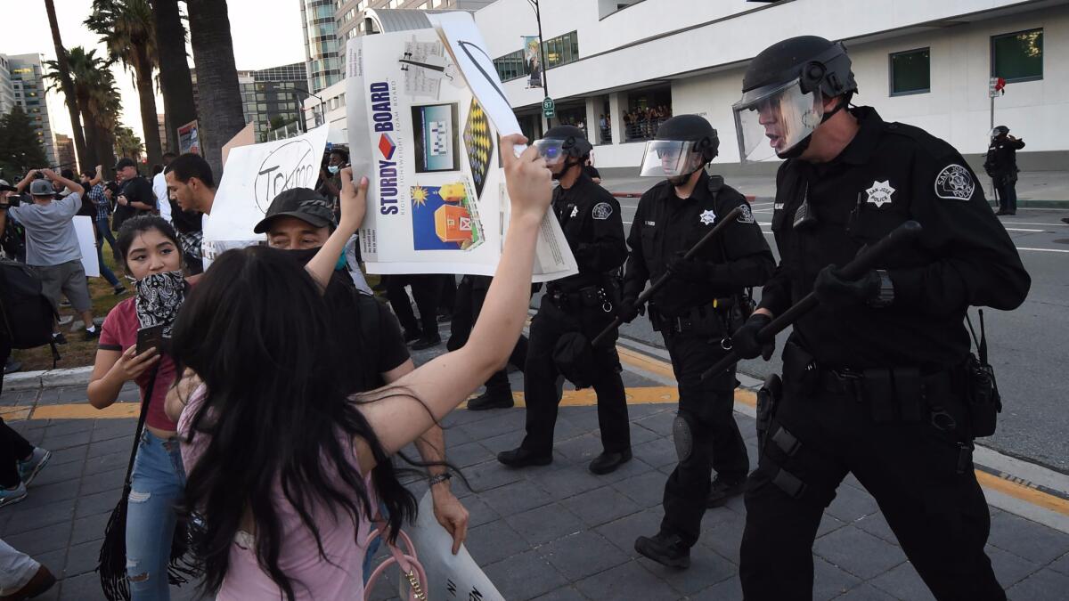 San Jose police move in to disperse a crowd of protesters outside a Thursday rally for Republican presidential candidate Donald Trump.