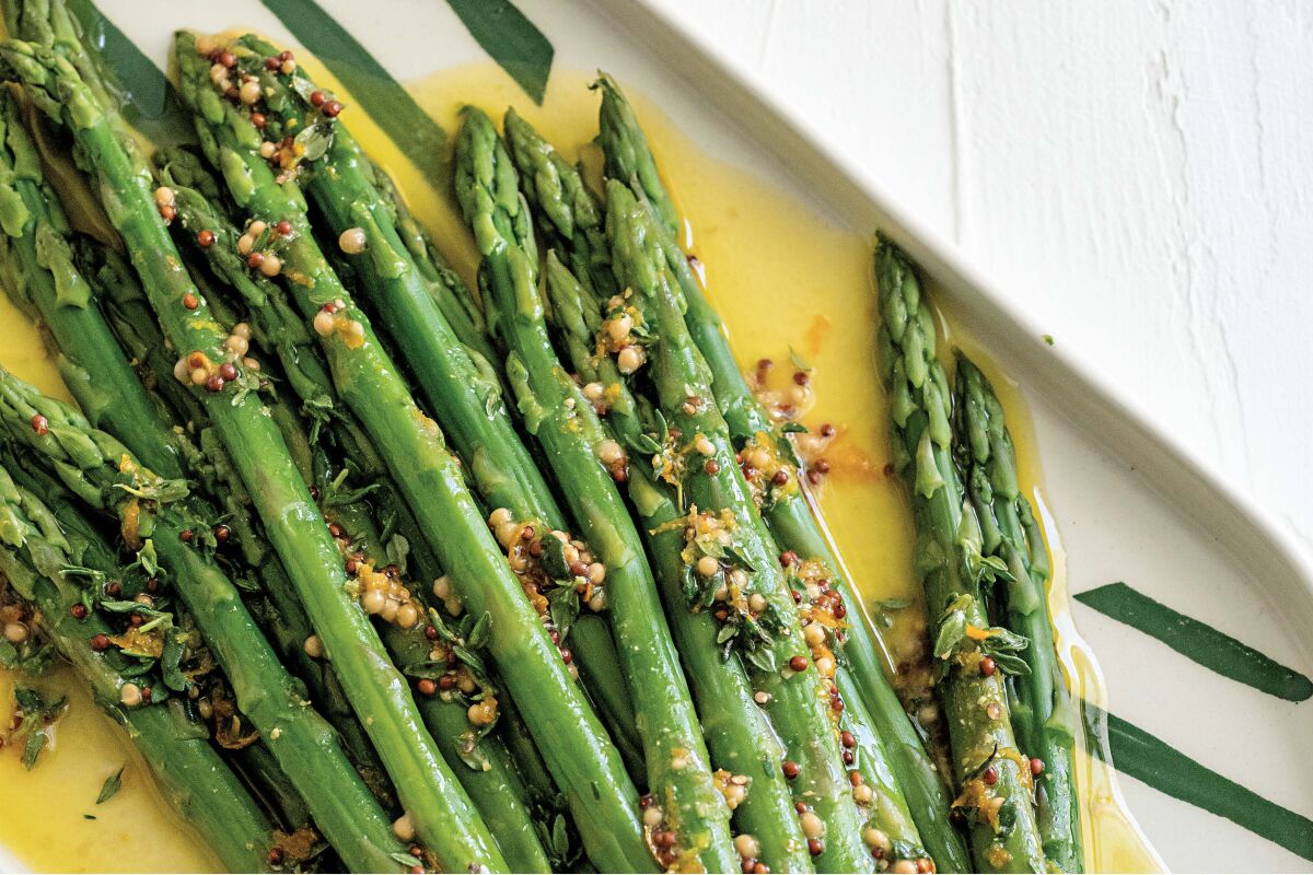 Spears of asparagus in a yellow sauce