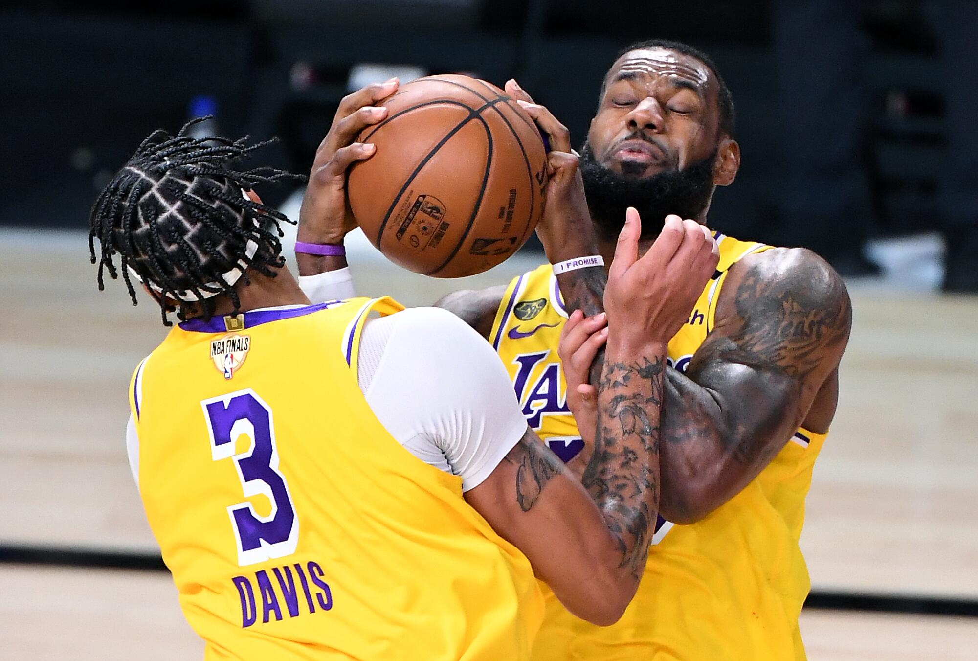 Lakers forwards LeBron James and Anthony Davis collide as they try to grab a rebound during Game 1.