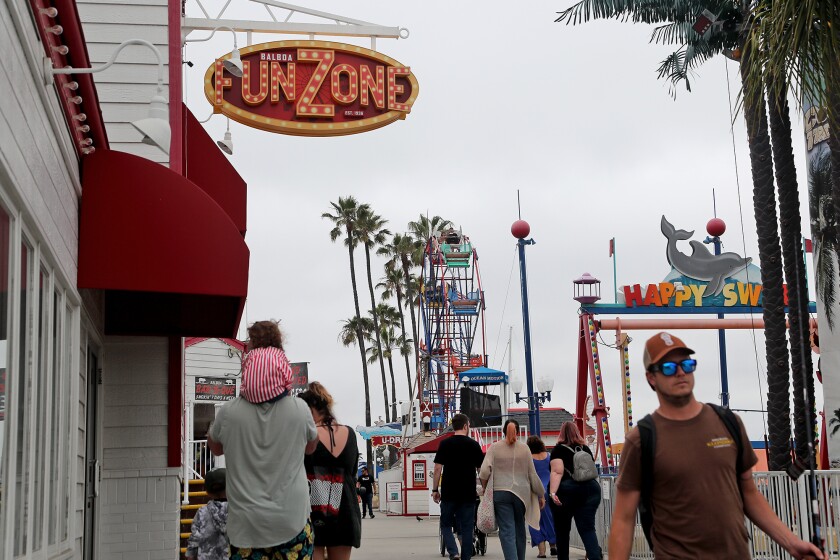 Visitors to the Balboa Fun Zone in Newport Beach on Wednesday. 
