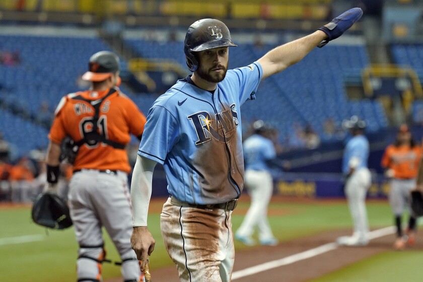 Tampa Bay Rays' Brandon Lowe reacts after scoring on an RBI double by Joey Wendle off Baltimore Orioles pitcher Jorge Lopez during the first inning of a baseball game Saturday, June 12, 2021, in St. Petersburg, Fla. (AP Photo/Chris O'Meara)
