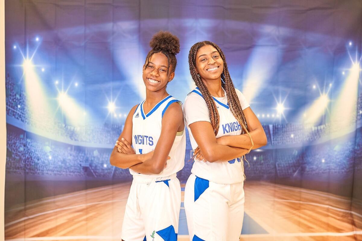 Freshman Jade Fort and senior Kaziah Fletcher pose for a photo in front of an image of an arena.