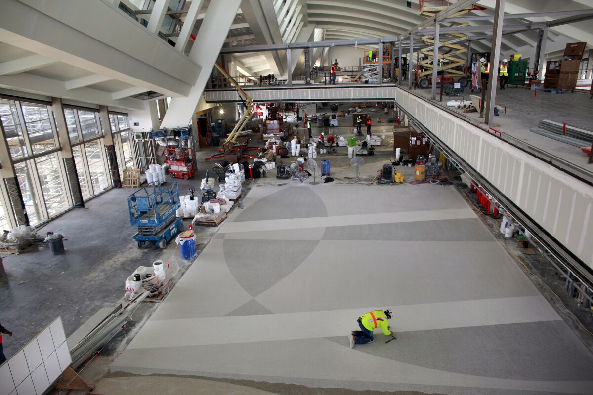 A construction worker examines the floor of the north concourse of the new Tom Bradley International Terminal construction site at Los Angeles International Airport in 2012. The project is part of a $8.5-billion modernization project.