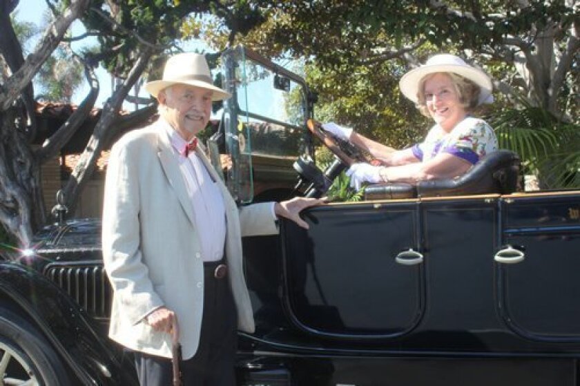lewis and connie Branscomb, event chair, pose with the ‘Old Black Goose,’ a 1915 Packard, on loan from the kellogg family as a backdrop for guest photos.