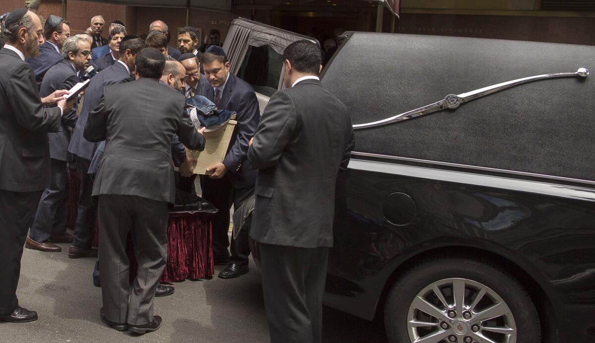 Family and friends carry Elie Wiesel's coffin during a private service for the Nobel laureate and Holocaust survivor at the Fifth Avenue Synagogue in New York on July 3, 2016.