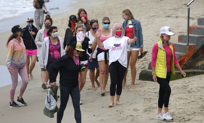 Sharael Kolberg of Laguna Beach walks past Brooks St. with her team during her "50 for the Cure" walk for her 50th birthday.