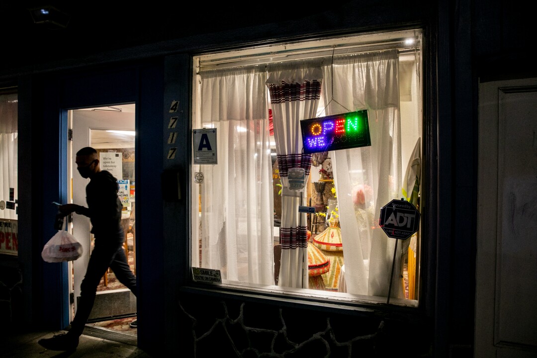 A delivery driver picks up a takeout order at Red Sea.