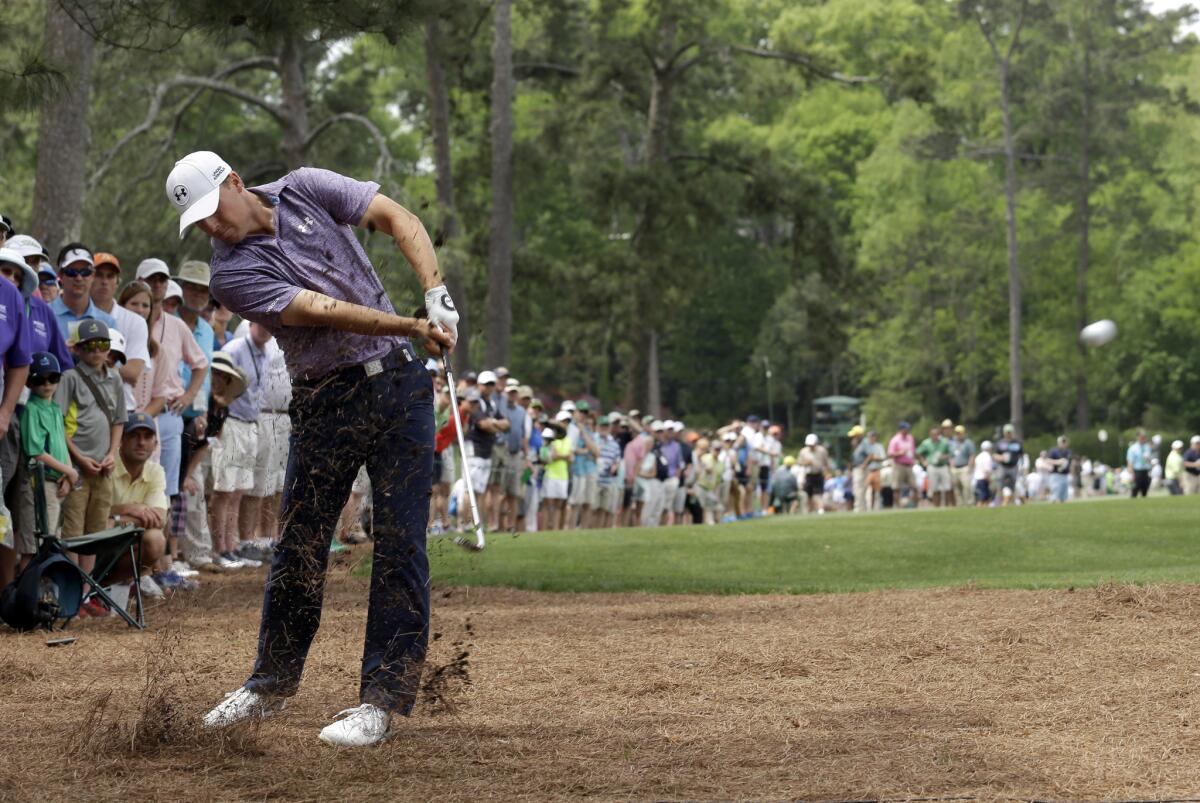 Jordan Spieth hits out of the rough at No. 14 on Friday during the second round of the Masters at Augusta National Golf Club.