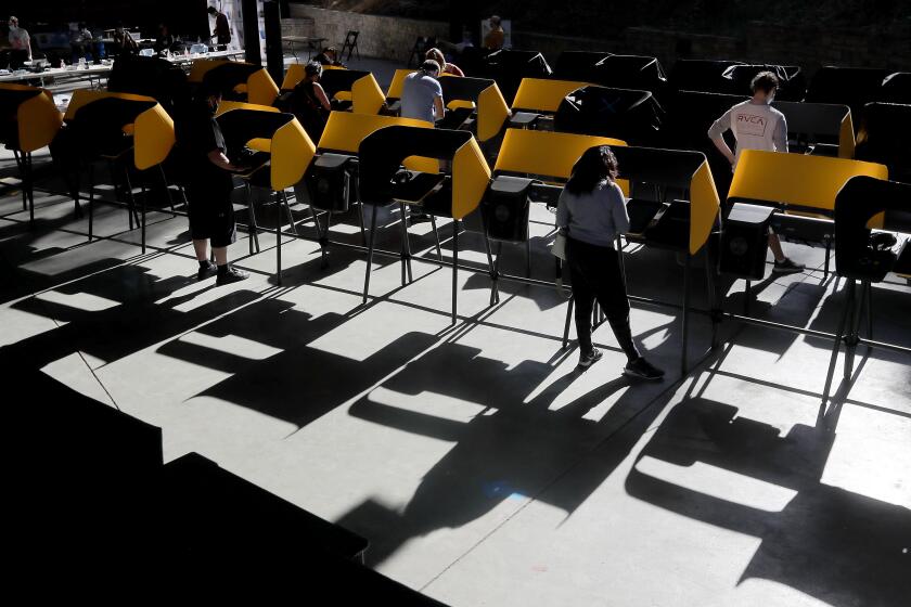 HOLLYWOOD, CA - OCT. 30, 2020. Voters fill out their ballots at the Hollywood Bowl, which was open for early voting on Friday, Oct. 30, 2020. (Luis Sinco / Los Angeles Times)