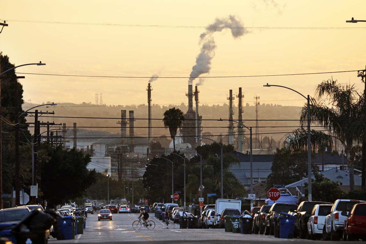 Oil refinery looms over a California street 