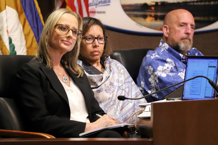 Huntington City Council Members, Natalie Moser, left, Rhonda Bolton and Huntington Beach Mayor Pro Tem Pat Burns, listen to a speaker during the Huntington Beach City Council meeting about taking the first step in privatizing its public library operations at the Huntington Beach City Council Chambers in Huntington Beach on Tuesday, March 19, 2024. (Photo by James Carbone)