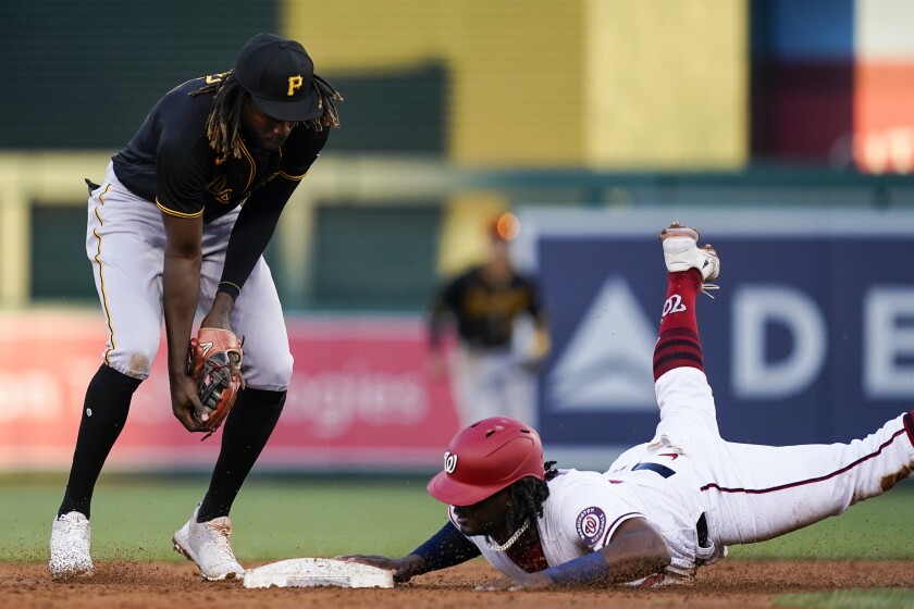 Washington Nationals' Josh Bell, right, is forced out at second base by Pittsburgh Pirates shortstop Oneil Cruz, left, during the third inning of a baseball game at Nationals Park, Monday, June 27, 2022, in Washington. (AP Photo/Alex Brandon)