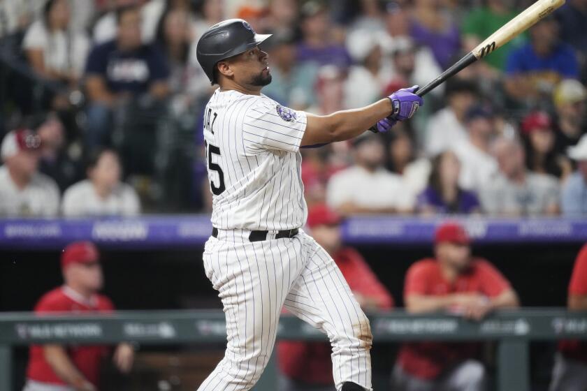 The Rockies' Elias Díaz watches his grand slam off Angels reliever Chris Devenski in the eighth inning June 23, 2023.