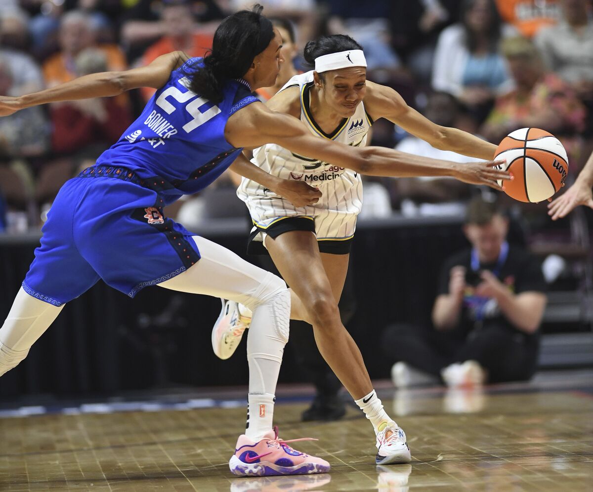 Connecticut Sun forward DeWanna Bonner (24) tries to slow Chicago Sky guard Rebekah Gardner during a WNBA basketball game Friday, June 10, 2022, in Uncasville, Conn. (Sean D. Elliot/The Day via AP)
