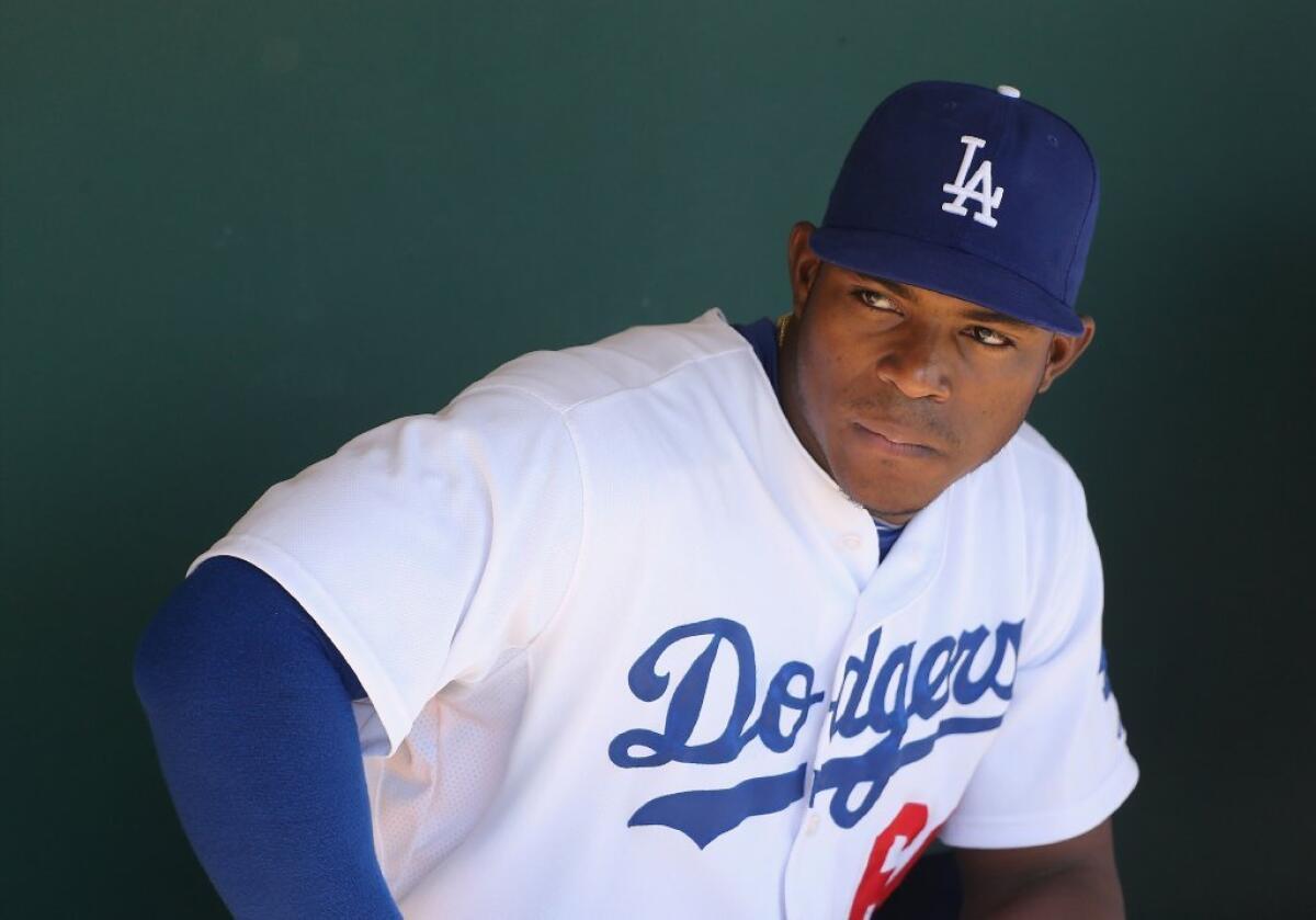 Yasiel Puig watches the Dodgers play the Oakland Athletics on Monday.