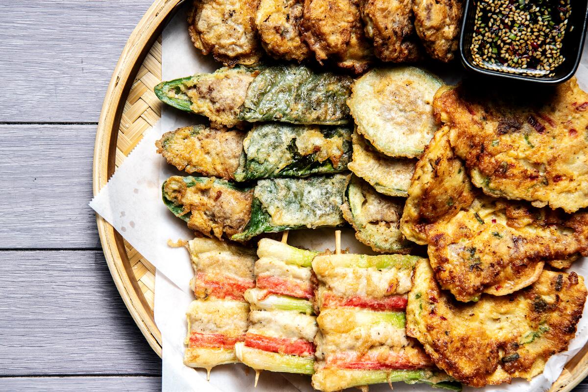 A platter filled with fritters and pancakes